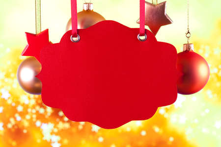 Red label, Christams baubles and stars on golden backgroundの写真素材