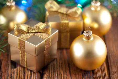 Gift boxes and Christmas balls on wooden tableの写真素材