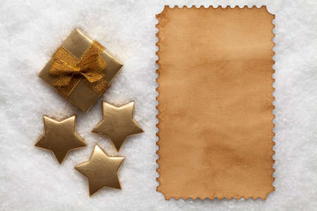 Paper sheet and ornaments on snowの写真素材