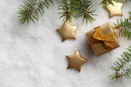 Christmas gift box and stars on snow
