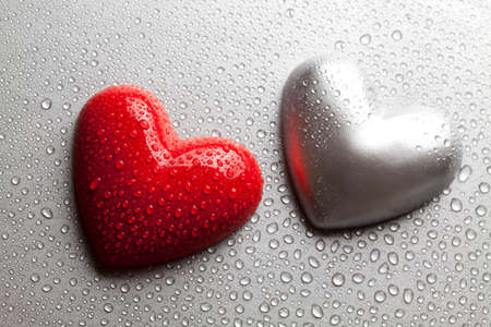 Two hearts dewy water on a metal plateの写真素材