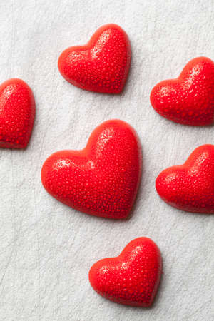Six red hearts on a scratched backgroundの写真素材