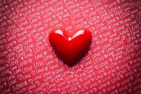 Red heart on paper backgroundの写真素材