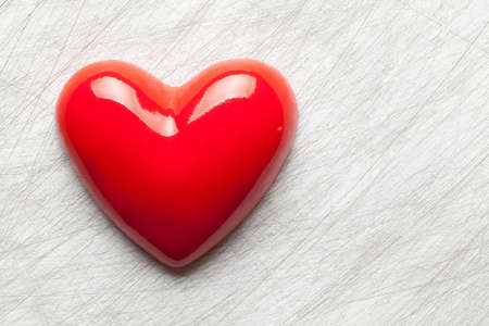 Red heart on scratched surface backgroundの写真素材