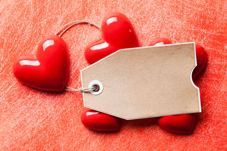 Blank paper label and red hearts on grunge backgroundの写真素材