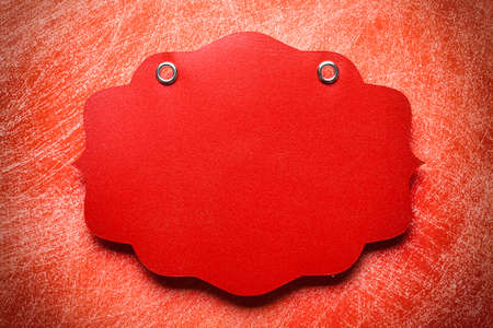 Red paper label on scratched backgroundの写真素材