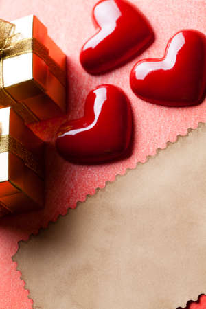 Red hearts, gift boxes and blank paper sheetの写真素材