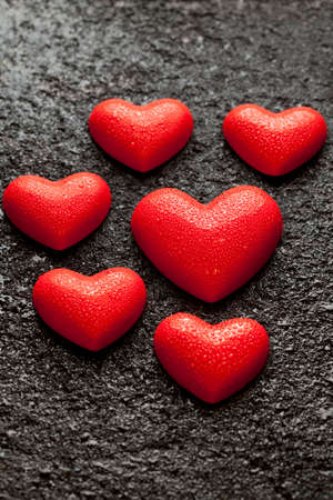 Red Valentine's Day hearts on a black backgroundの写真素材