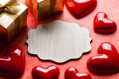 Red hearts, gift boxes and wooden labelの写真素材