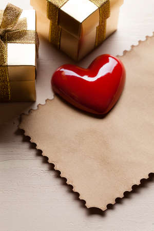 Red heart and two gold gift boxes and paper cardの写真素材