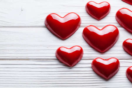Red hearts on white wooden planksの写真素材