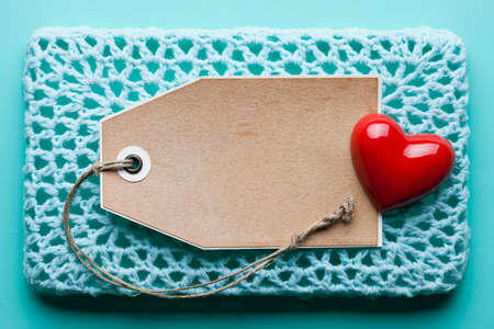 Blank paper label and red heart on blue backgroundの写真素材