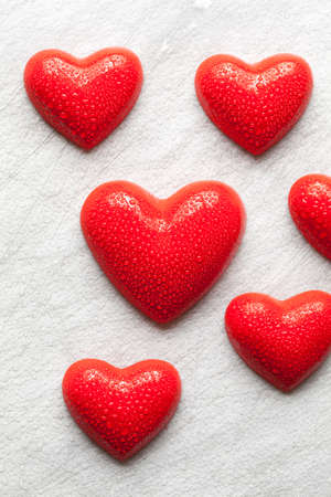 Red hearts covered with drops of waterの写真素材