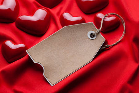 Blank paper label and red heartsの写真素材