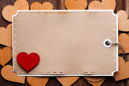 Blank paper sheet and wooden heartsの写真素材