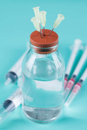 Glass bottle with medicine, needles and syringeの写真素材