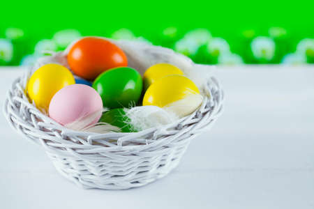 Easter eggs in white basketの写真素材