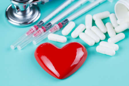 Stethoscope, pills and figure in the shape of heart as a symbol of health careの写真素材