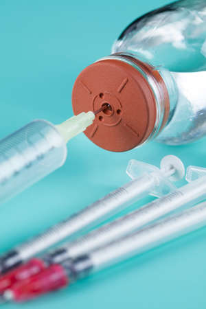Syringe and medicine bottle on a blue backgroundの写真素材