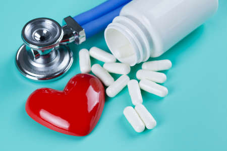 Stethoscope, pills and figure in the shape of heart as a symbol of health careの写真素材