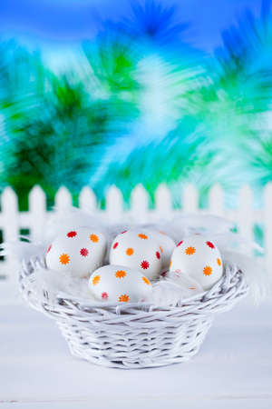Patterned easter eggs in the basket on abstract backgroundの写真素材