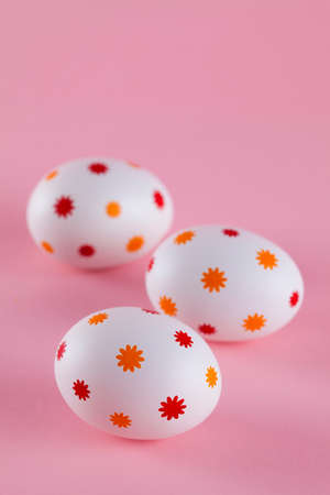 Three easter eggs on pink backgroundの写真素材