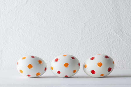 Patterned easter eggs on plastered backgroundの写真素材