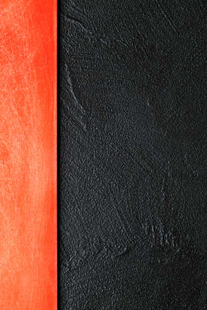 Two layer background - red scratched surface on black plastered wallの写真素材