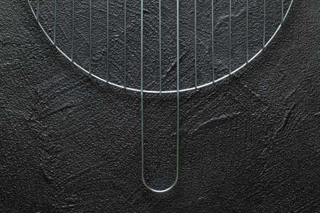 Metal grill grate on black plastered backgroundの写真素材
