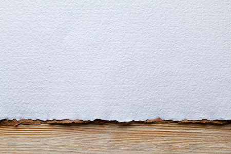 White paper sheet on wooden planksの写真素材
