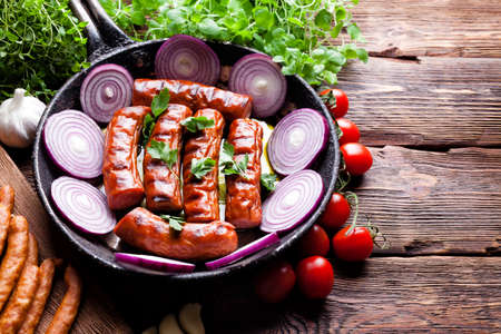 Food ingredients - Grilled meat, vegetables and herbs on wooden boardの写真素材