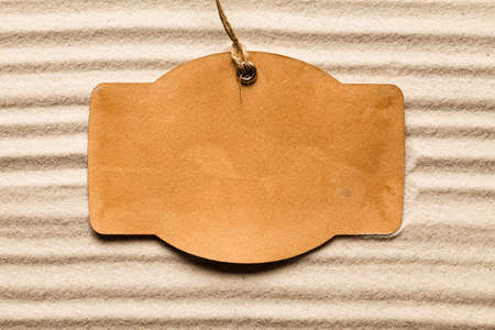 Blank paper label on beach sandの写真素材