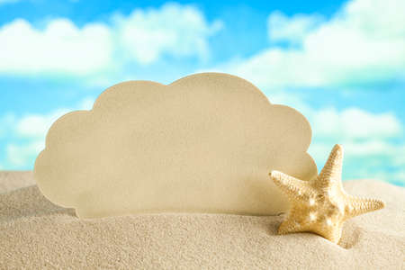 Blank paper sheet and starfish on beach sandの写真素材