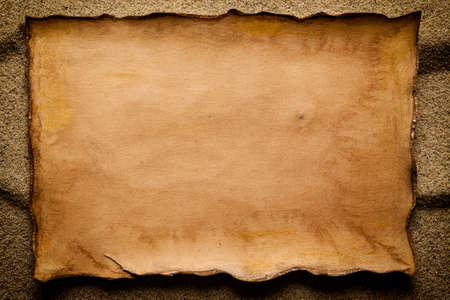 Handmade paper sheet on sandの写真素材