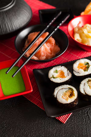 Traditional japanese cuisine - sushi set on red mat and black tableの写真素材