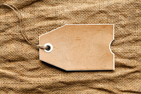 Paper tag on crumpled fabric backgroundの写真素材