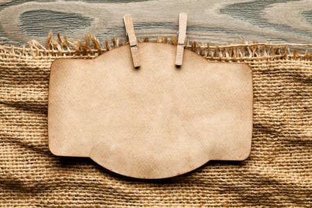 Blank paper label on canvas and wooden backgroundの写真素材
