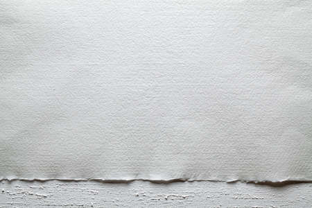 Two layer background - paper sheet on white plastered wallの写真素材