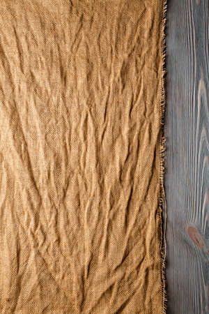Crumpled canvas material on wooden planks backgroundの写真素材