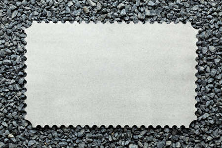 Blank paper sheet on gravel backgroundの写真素材