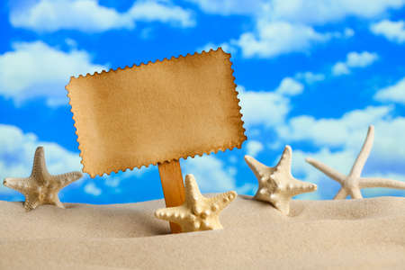 Blank paper sheet and starfish on beachの写真素材