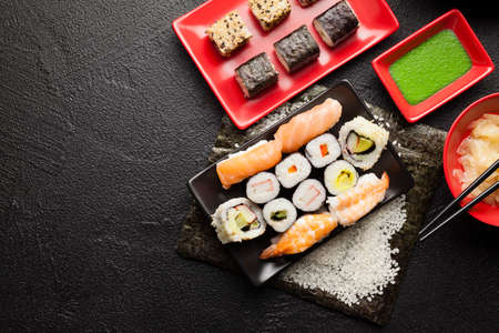 Sushi set on red and black dishes and black table backgroundの写真素材