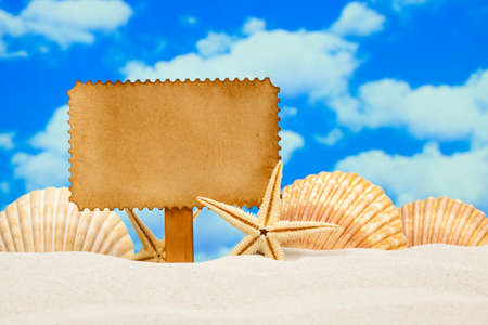 Blank paper label and starfishes on the beachの写真素材
