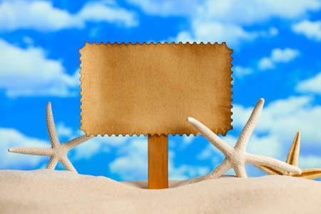 Summer background - blank paper sheet and starfish on beachの写真素材