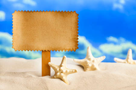 Paper sheet and starfish on beachの写真素材