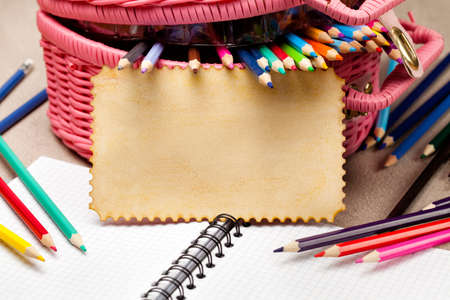 Blank paper card and basket full of pencilsの写真素材