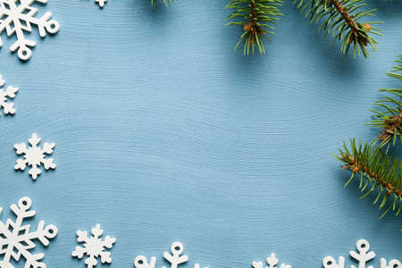 Christmas background - spruce tree and snowflakes on blue backgroundの写真素材