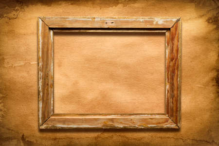 Old damaged wooden picture frame on paper backgroundの写真素材