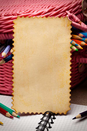 Blank paper card and basket full of pencilsの写真素材