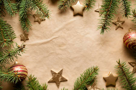 Christmas background - paper sheet, stars, baubles and spruce treeの写真素材